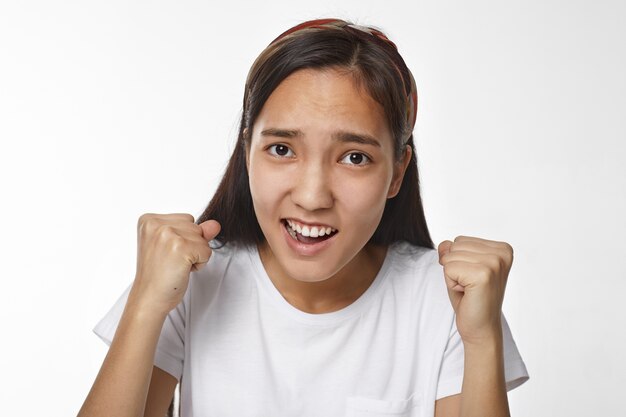 Expressive Asian girl posing indoor