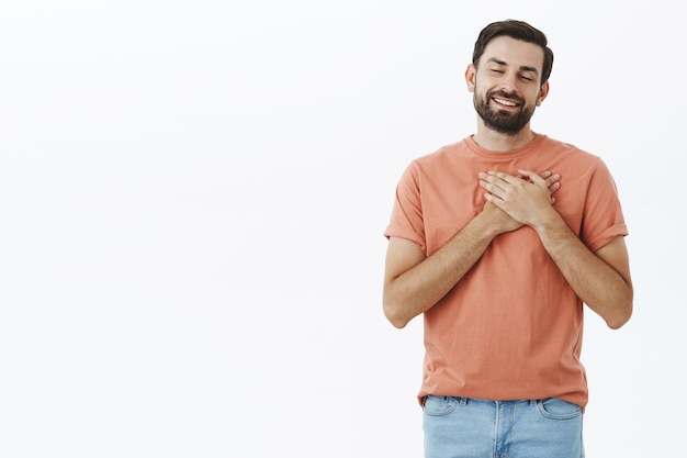 オレンジ色のTシャツで表現力豊かなひげを生やした男