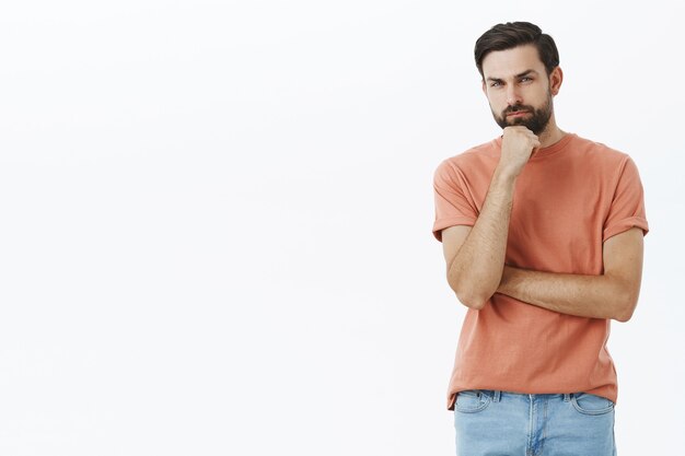 Expressive bearded man in orange Tshirt