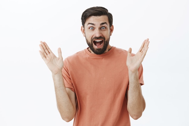 Expressive bearded man in orange Tshirt