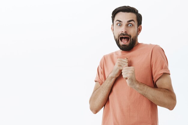 Expressive bearded man in orange Tshirt