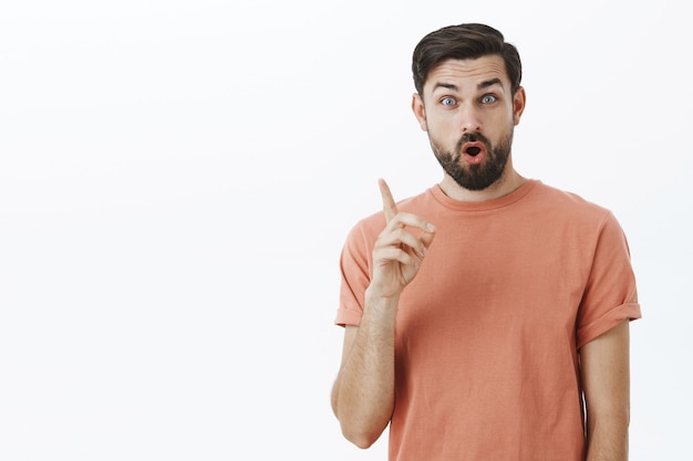 Expressive bearded man in orange Tshirt