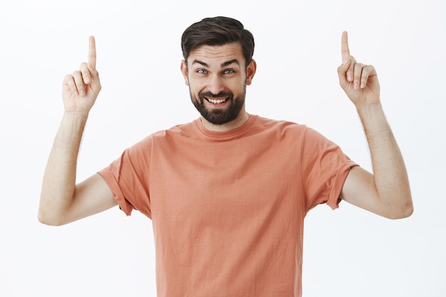 Expressive bearded man in orange Tshirt