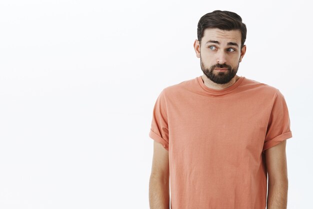 Expressive bearded man in orange Tshirt