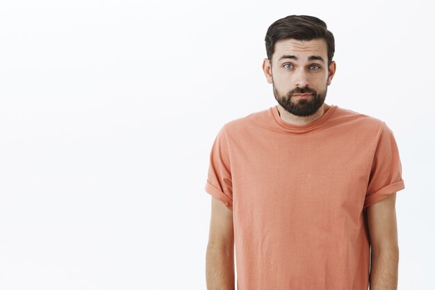 Expressive bearded man in orange Tshirt