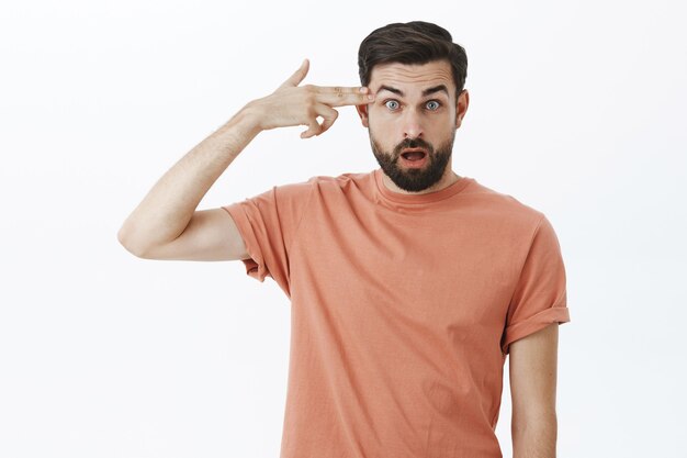 Expressive bearded man in orange Tshirt