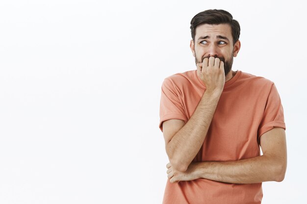 Expressive bearded man in orange Tshirt