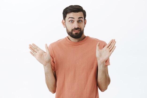 Expressive bearded man in orange Tshirt