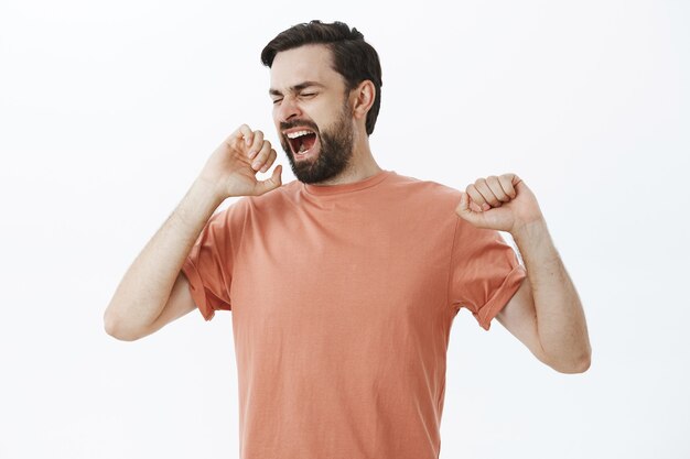 Expressive bearded man in orange Tshirt