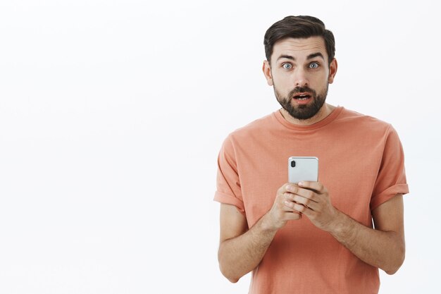 Expressive bearded man in orange Tshirt