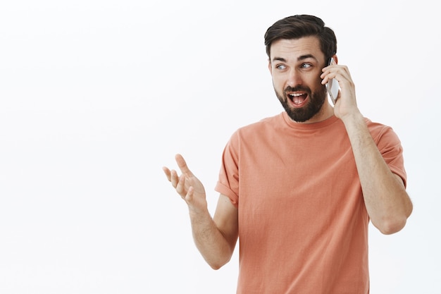 Expressive bearded man in orange Tshirt