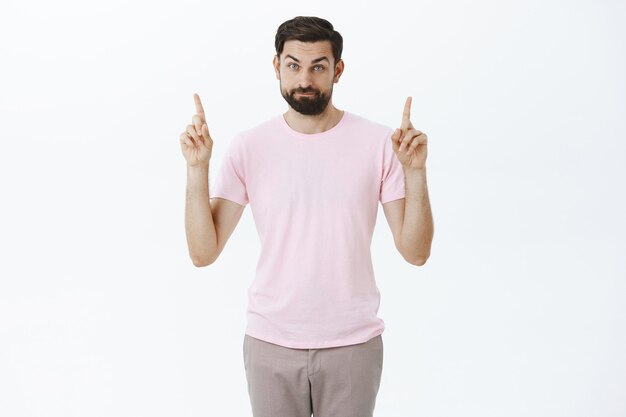 Expressive bearded man in pink Tshirt