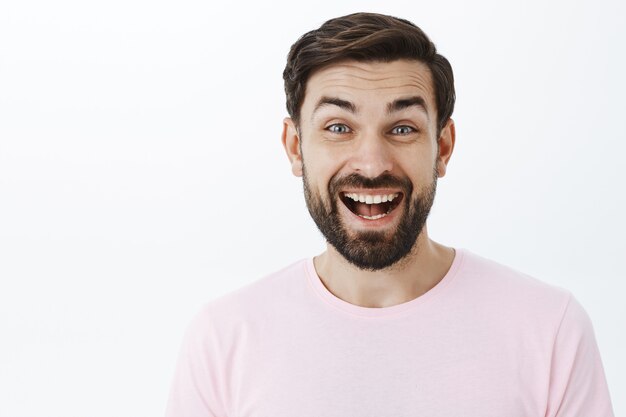 Expressive bearded man in pink Tshirt