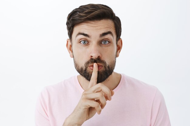 Expressive bearded man in pink Tshirt