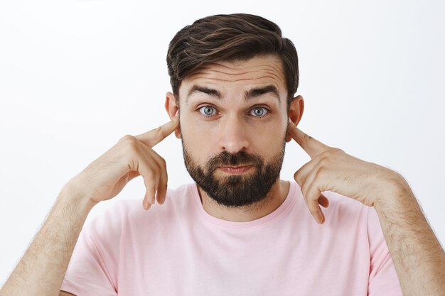 Expressive bearded man in pink Tshirt