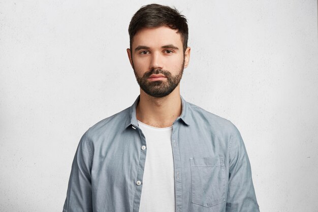 Expressive bearded man wearing shirt