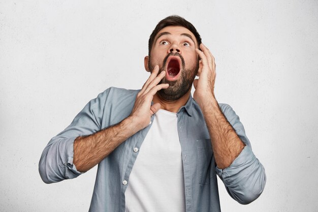 Expressive bearded man wearing shirt