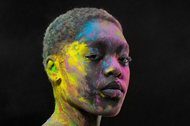 Expressive black model posing with colorful powder