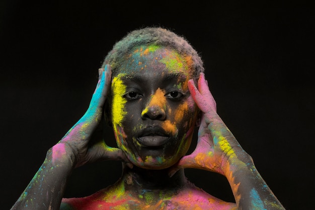 Expressive black model with colorful powder