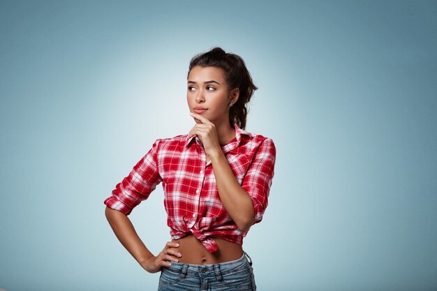 Expressive brunette woman wearing striped shirt