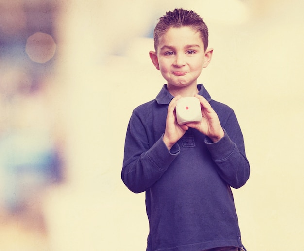 Expressive child showing a die