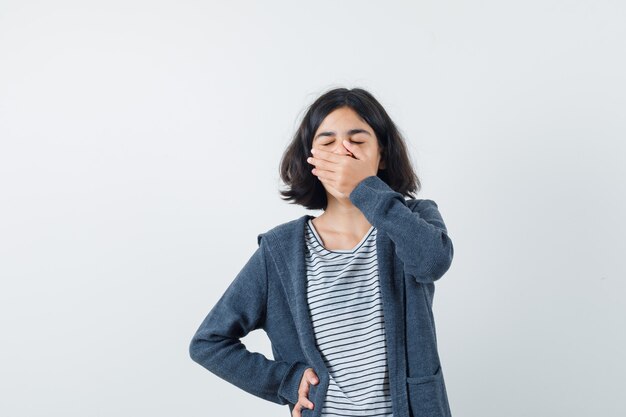 An expressive girl is posing in the studio