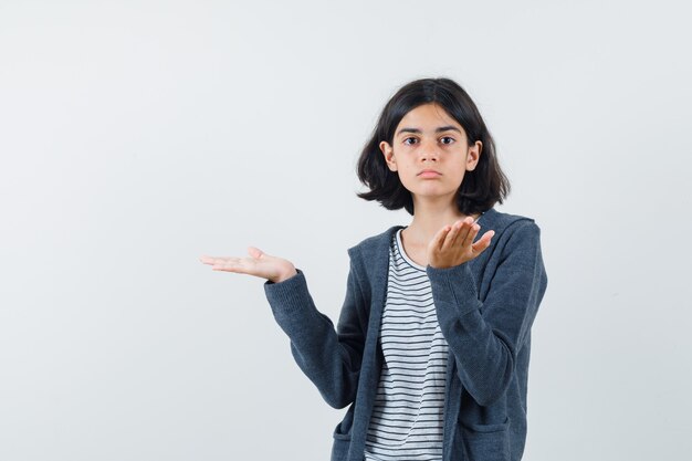 An expressive girl is posing in the studio