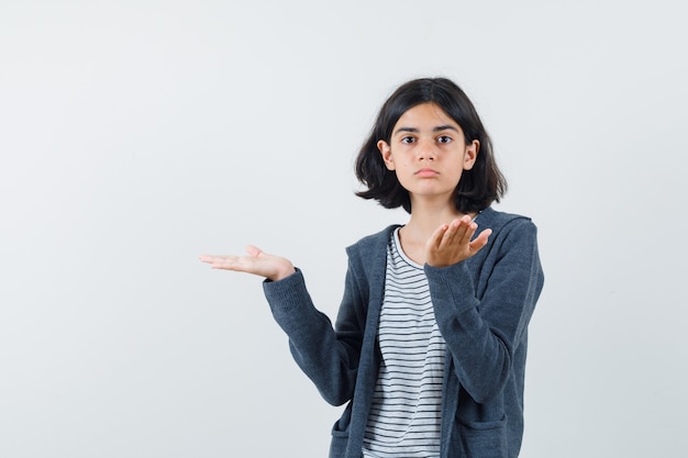 An expressive girl is posing in the studio