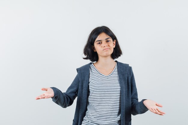 An expressive girl is posing in the studio