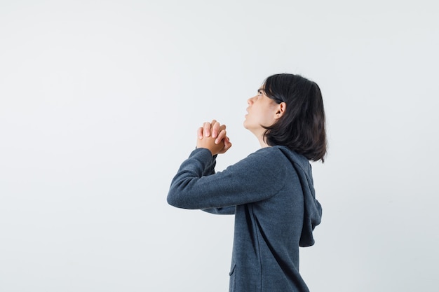 An expressive girl is posing in the studio