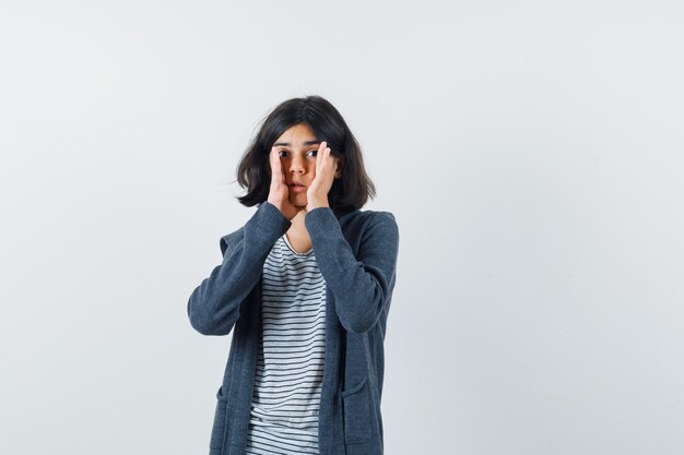 An expressive girl is posing in the studio