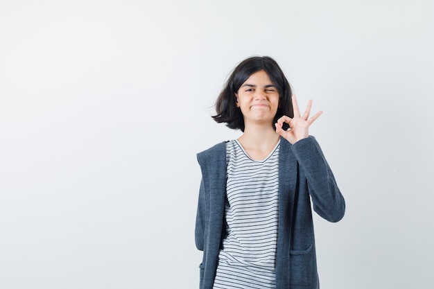 An expressive girl is posing in the studio