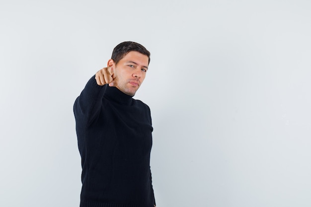 An expressive man is posing in the studio