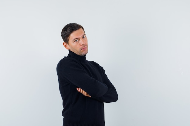 An expressive man is posing in the studio