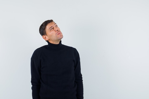 An expressive man is posing in the studio