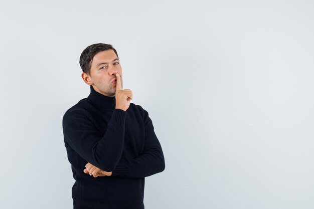 An expressive man is posing in the studio