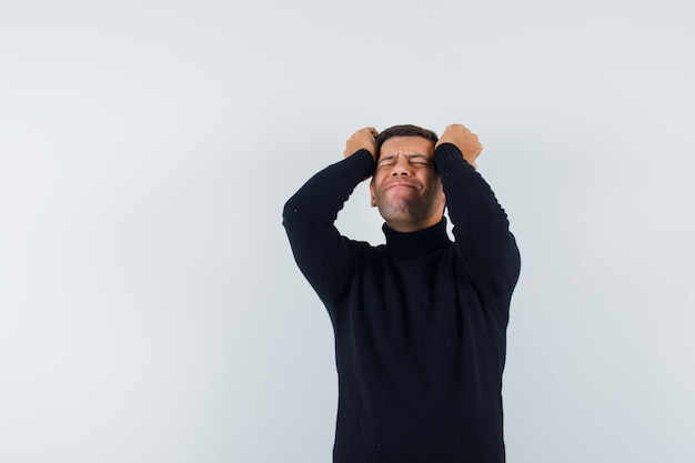 An expressive man is posing in the studio