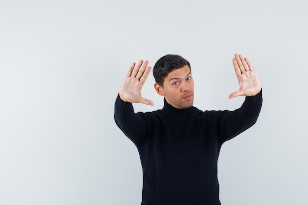 An expressive man is posing in the studio