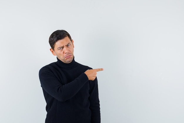 An expressive man is posing in the studio