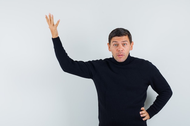 An expressive man is posing in the studio