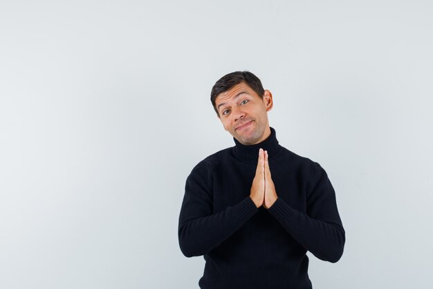 An expressive man is posing in the studio