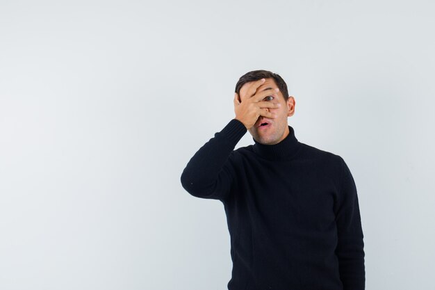 An expressive man is posing in the studio