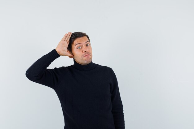 An expressive man is posing in the studio