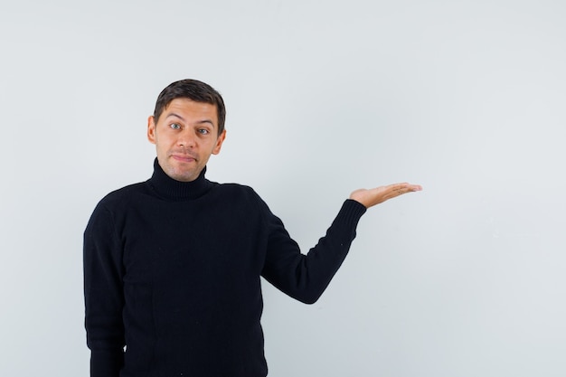 An expressive man is posing in the studio