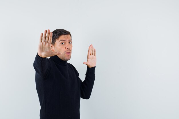 An expressive man is posing in the studio