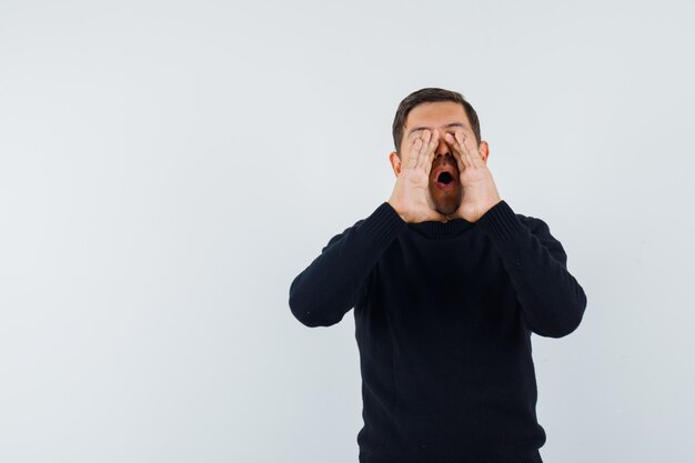 An expressive man is posing in the studio