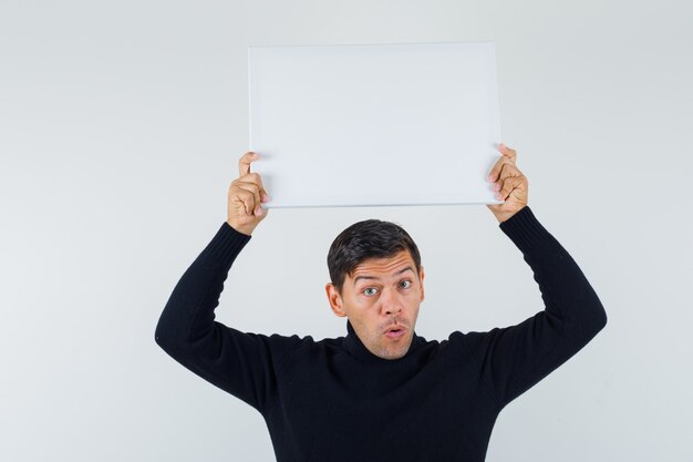 An expressive man is posing in the studio