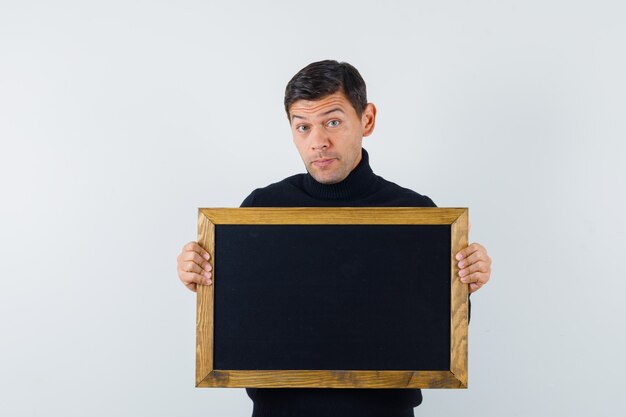 An expressive man is posing in the studio