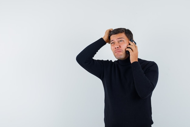 An expressive man is posing in the studio