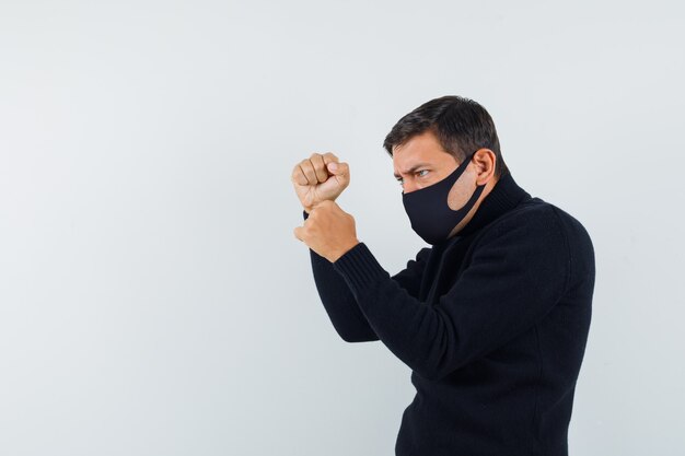 An expressive man is posing in the studio